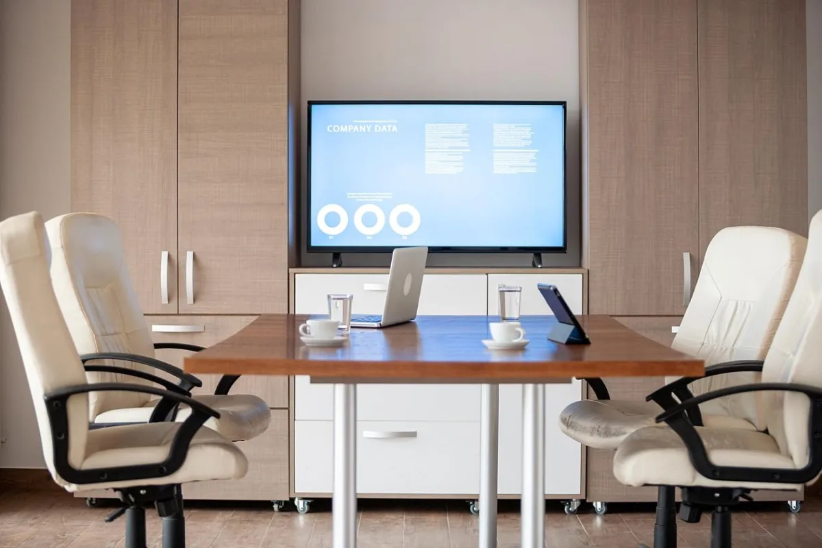 empty-business-meeting-conference-room-with-graphs-diagrams-tv-background.jpg