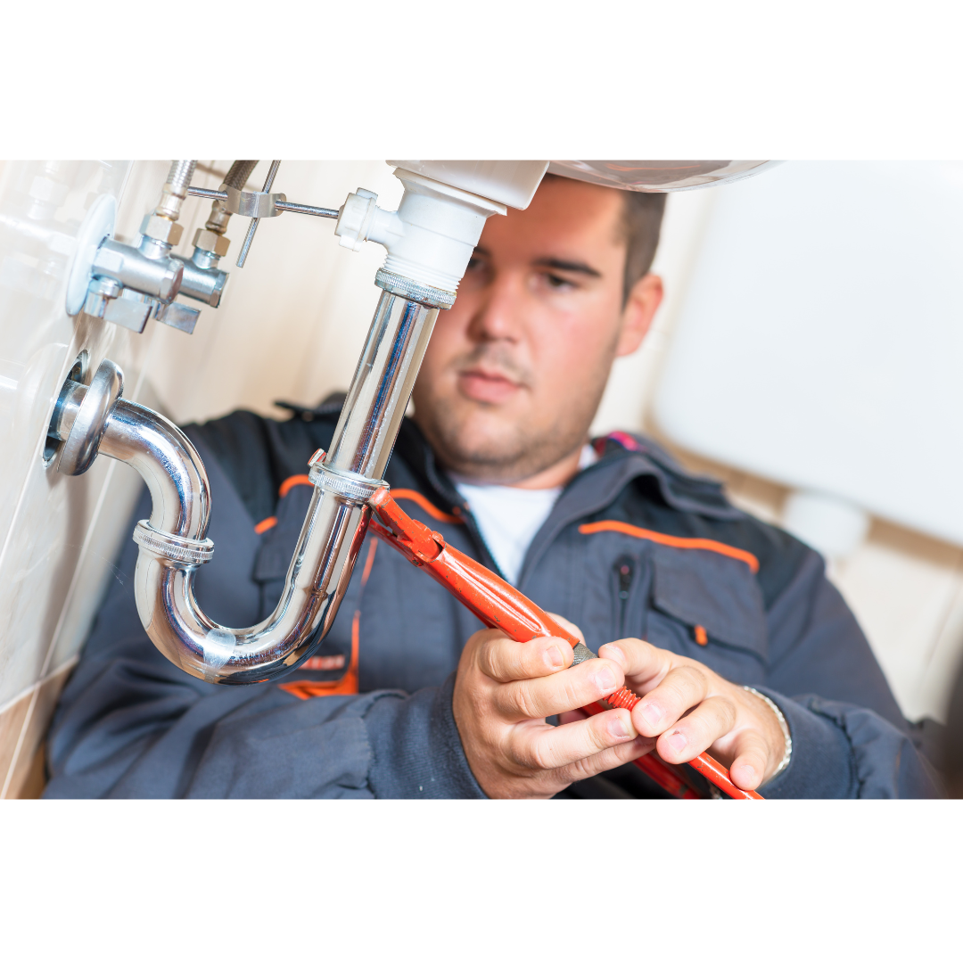 A person fixing a pipe
Description automatically generated