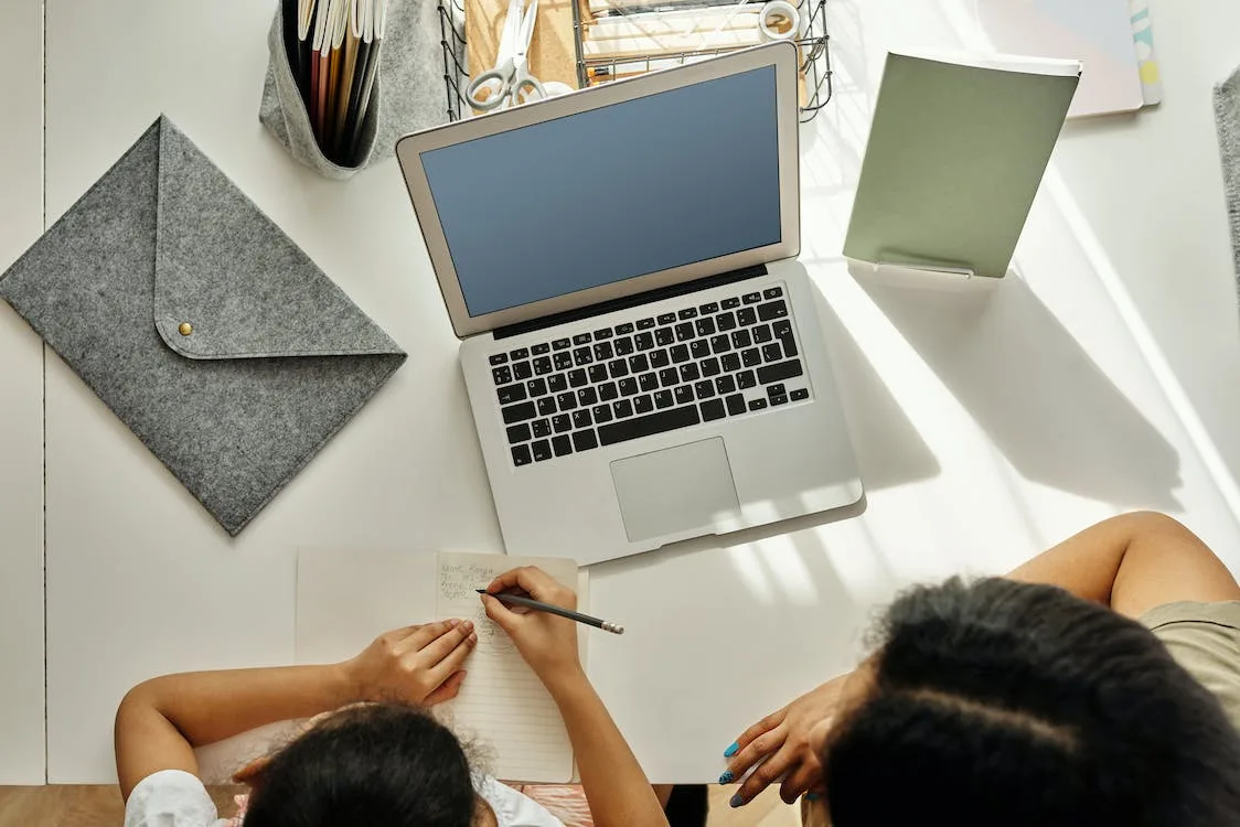 Free Mother Helping her Daughter with her Homework Stock Photo