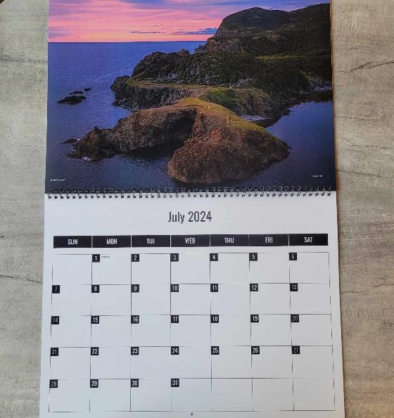 A calendar with a picture of a land and a sunset

Description automatically generated