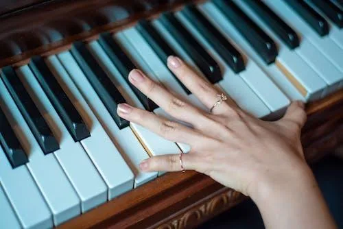 Free Brown Wooden Piano Used by a Person Using 2 Fingers Stock Photo